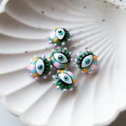 Perla di vetro tonda appiattita da 17 mm - motivo occhi - Rosa - Azzurro - Verde x1