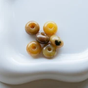 Perle rotonde 12x7 mm in resina traslucida - Ambra marmorizzata chiara x6