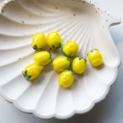 Perla di vetro Lemon 13x11 mm - Giallo - Foglia verde x1