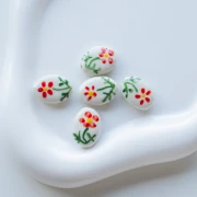 Perlina ovale in ceramica 19,5x14,5 mm - Motivo floreale - Bianco - Rosso - Verde x1