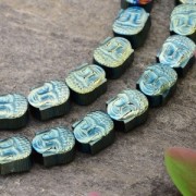 Perlina in Ematite sintetico Testa di Budda 8.5x7x4 mm Light Green Metallic x1