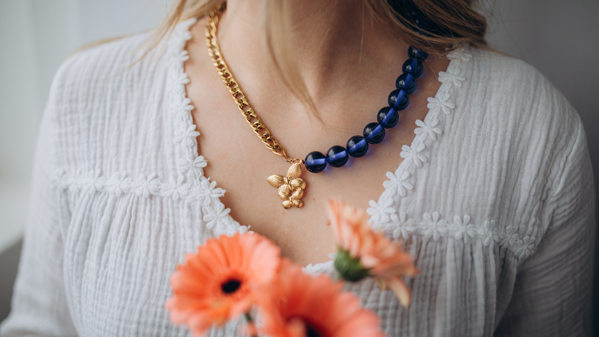 Collana con grandi perle e pendente a forma di farfalla